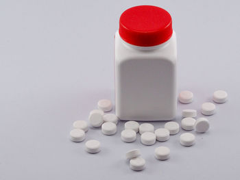 High angle view of bottles in container over white background