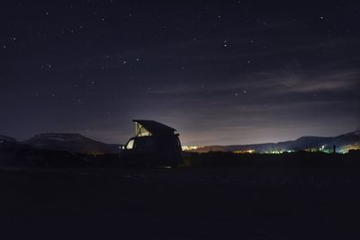 Silhouette built structure against sky at night