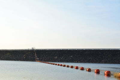 Scenic view of shore against clear sky