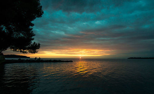 Scenic view of sea against dramatic sky