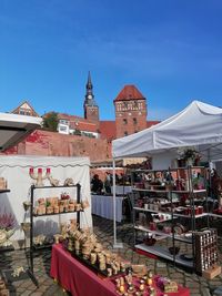 Panoramic view of buildings in city against blue sky