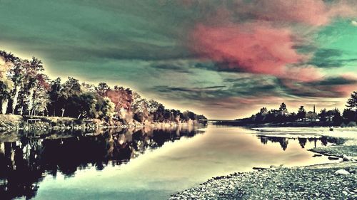 Scenic view of lake against cloudy sky