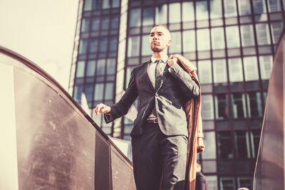 Low angle view of man standing in front of building