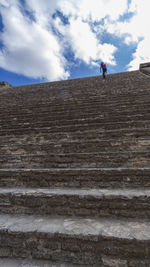 Low angle view of people on staircase against sky