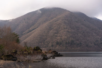 Scenic view of sea and mountains against sky