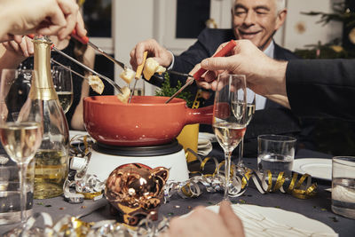 Friends eating cheese fondue on new year's eve