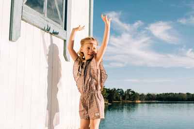 Girl dressed up using her imagination dancing at the beach on her own