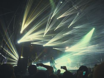 People enjoying music concert at night