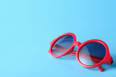 Close-up of eyeglasses against blue background