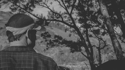 Rear view of woman wearing hat against trees