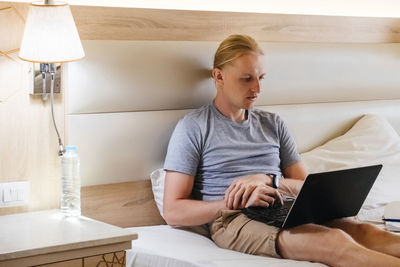 Young man using laptop while sitting at home