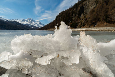 Silvaplana, switzerland, february 21, 2023 winter landscape scenery with a frozen lake of silvaplana