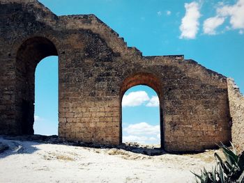 Low angle view of old ruins against sky