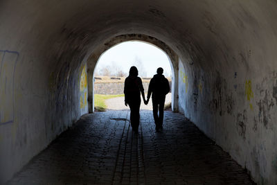 Silhouette of two people, couples, in the tunnel