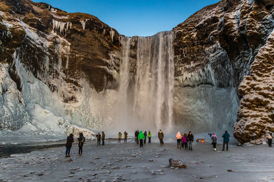 People standing on rock formation