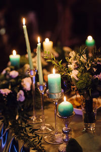 Close-up of illuminated candles on table