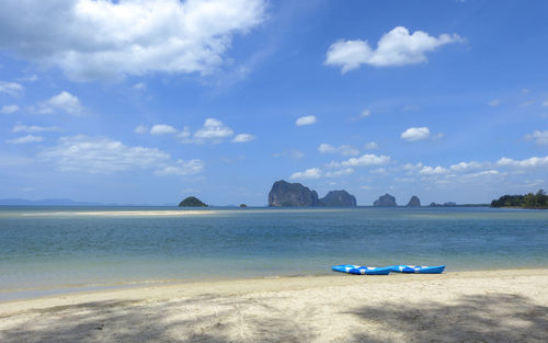 Scenic view of beach against blue sky