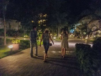 Group of people walking on road at night