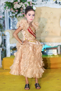 Portrait of girl wearing dress standing in wedding ceremony