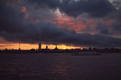 View of harbor against cloudy sky