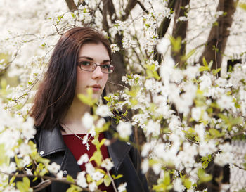 Portrait of beautiful woman with red flowers