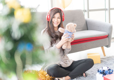 Portrait of smiling young woman sitting outdoors