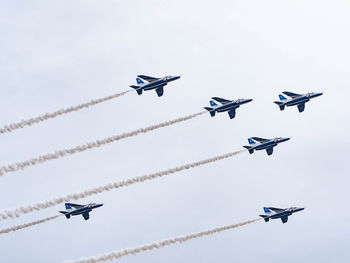 Low angle view of airshow against sky