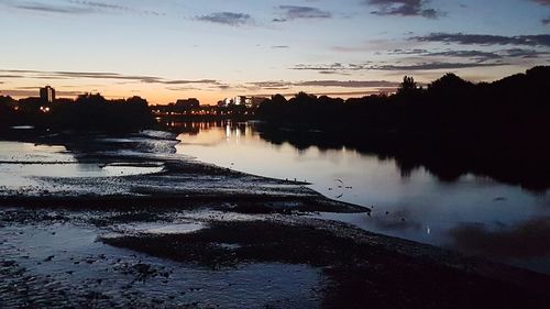 Scenic view of lake against sky at sunset