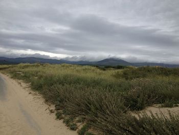 Scenic view of landscape against cloudy sky