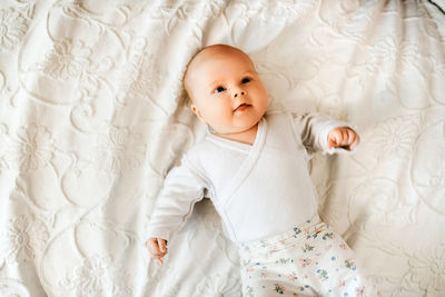 Portrait of cute baby boy sleeping on bed at home