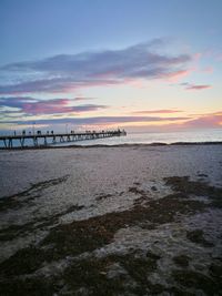 Scenic view of beach against sky during sunset