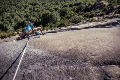 Overhead view of a girl climbing a wall without grips