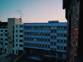 Buildings in city against clear sky