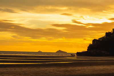 Scenic view of beach against sky during sunset