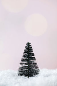 Christmas tree in the snow on a pink background. minimalism. the concept of the new year 