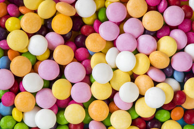 Skittles candy on the colorful table, colorful sweet candy background