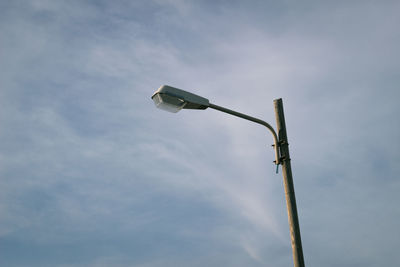 Low angle view of telephone pole against sky