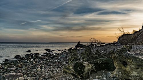 Scenic view of calm sea against cloudy sky