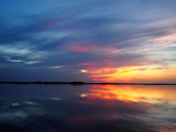 Scenic view of lake against romantic sky at sunset