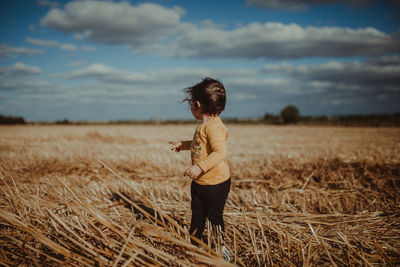 Full length of a girl standing on field