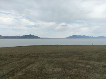 Scenic view of lake against cloudy sky