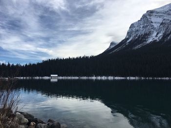 Scenic view of lake in forest against sky