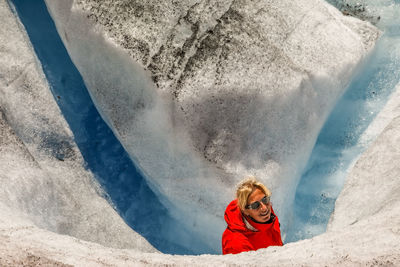 Portrait of woman climbing on snow covered mountain