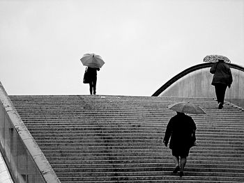 Rear view of man walking up stairs