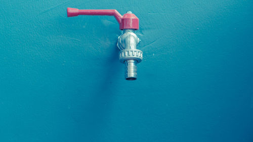 Faucet on blue wall