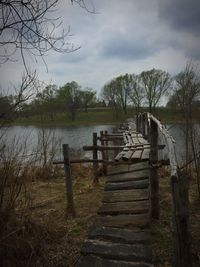 Pier over lake against sky