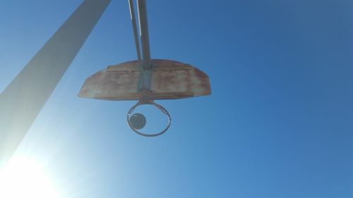 Low angle view of hanging light against clear blue sky