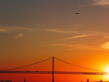 View of suspension bridge against sky during sunset