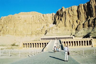 People walking in front of historical building