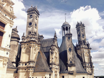 Low angle view of historical building against cloudy sky